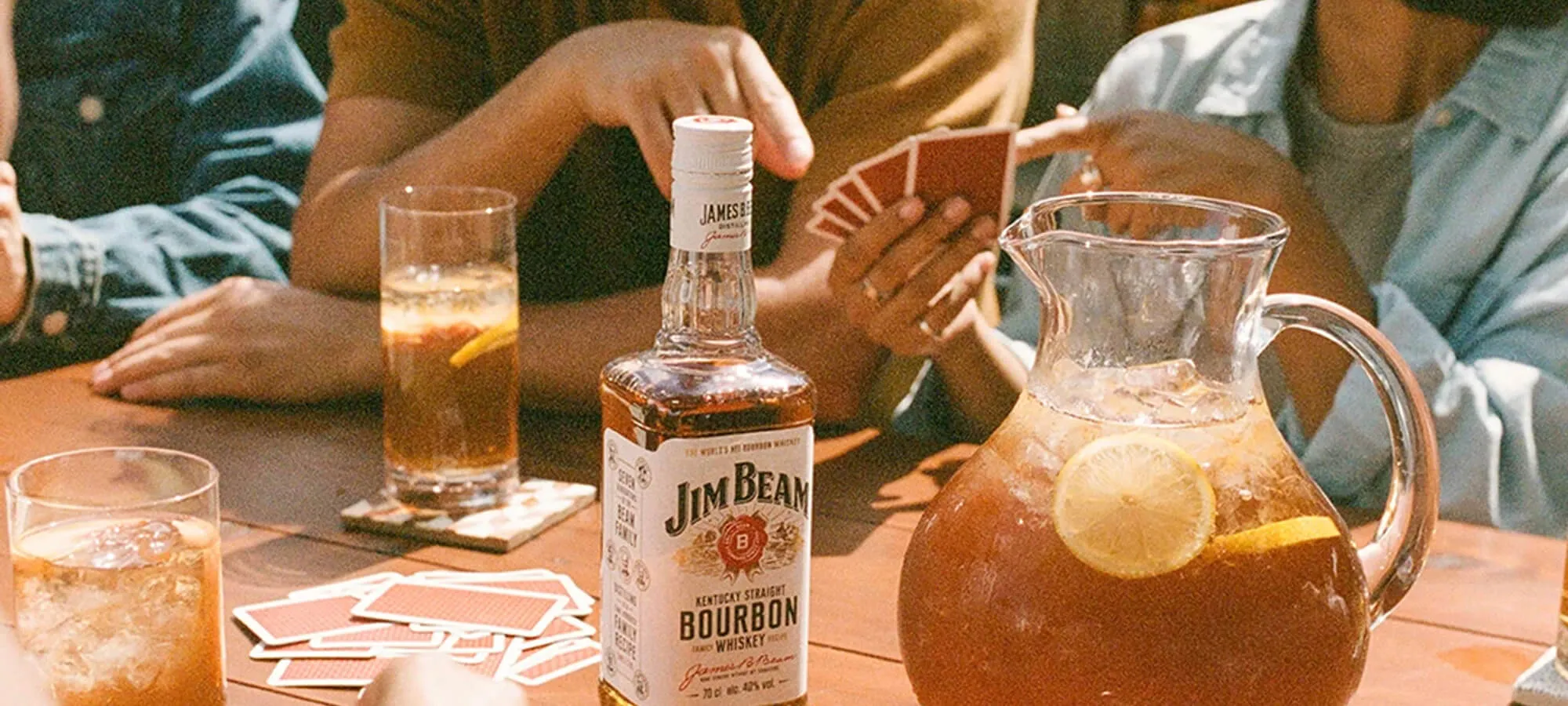 People playing card game and having fun with Jim Beam seasonal cocktails